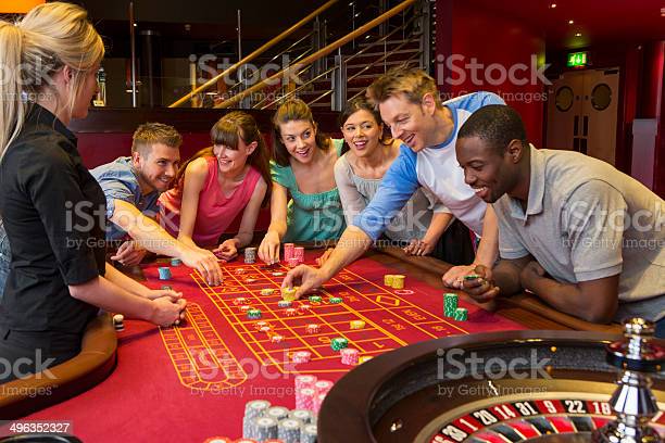 Group Of Friends Playing Roulette In Casino