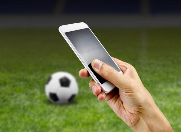 betting man through his smart phone in at stadium